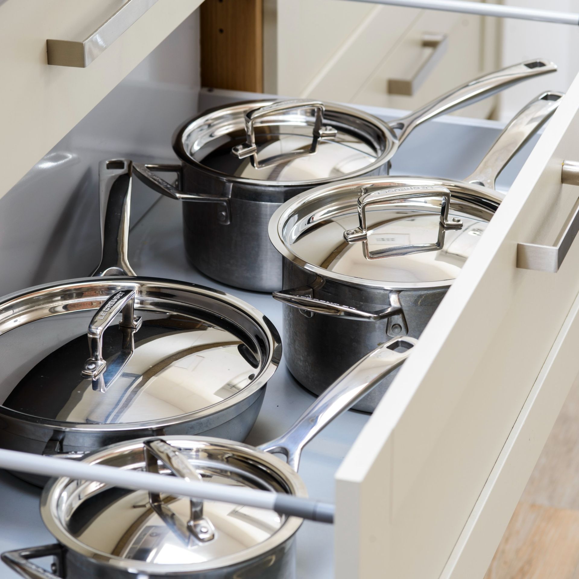 A kitchen drawer full of pots and pans