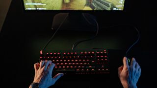 A person playing a PC game on their desktop.