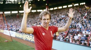 LIVERPOOL, UK - AUGUST 12: (THE SUN OUT) Phil Neal of Liverpool acknowledges the supporters in front of the Kop prior to the start of his testimonial match between Liverpool and Everton held on August 12, 1985 at Anfield, in Liverpool, England. (Photo by Steve Hale/Liverpool FC via Getty Images)