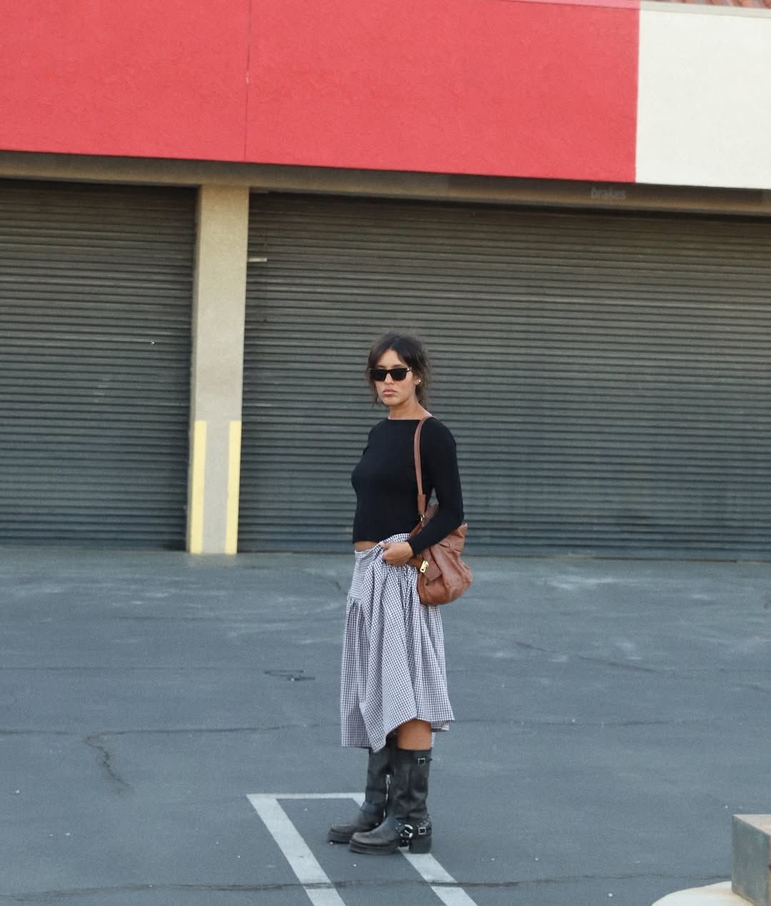 Christina Caradona in a midi skirt and moto boots