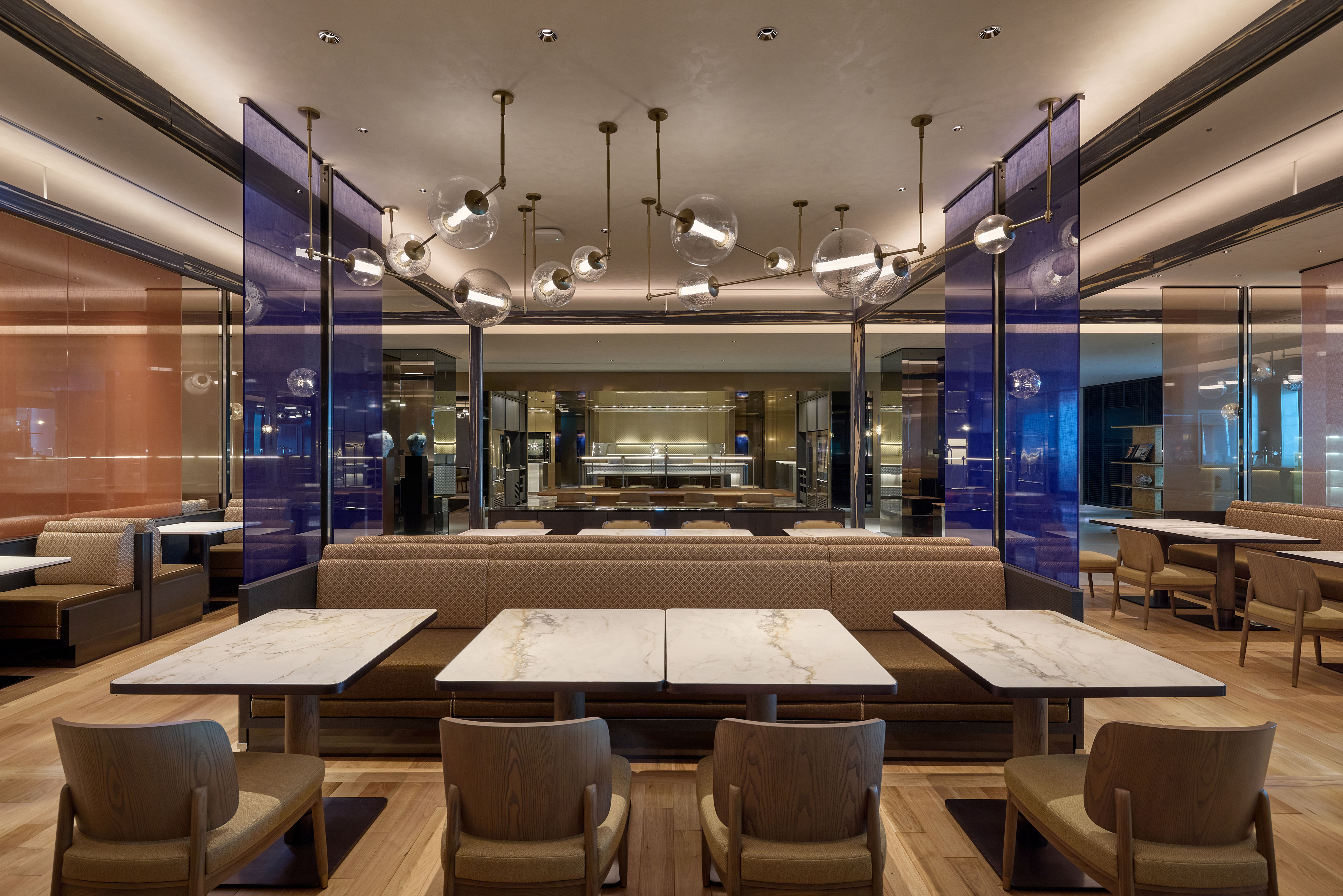 A spacious lounge interior at Incheon International Airport combines contemporary furnishings, natural textures and distinct areas for dining, work and relaxation