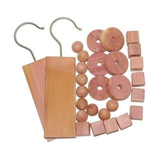 28 pieces of different sized cedarwood on a white background