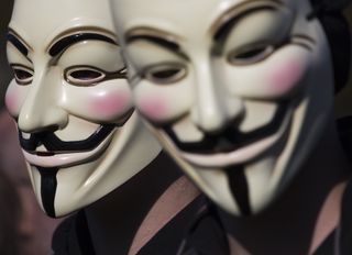 Two masked members of Anonymous demonstrating during the Occupy protest on October 15, 2011 in The Hague