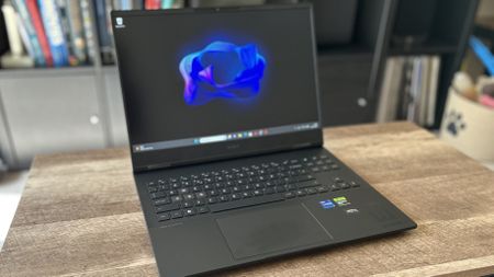 HP Omen Transcend laptop on a wooden table