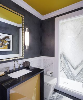 bathroom with sink and dark grey wall with gen z yellow ceiling