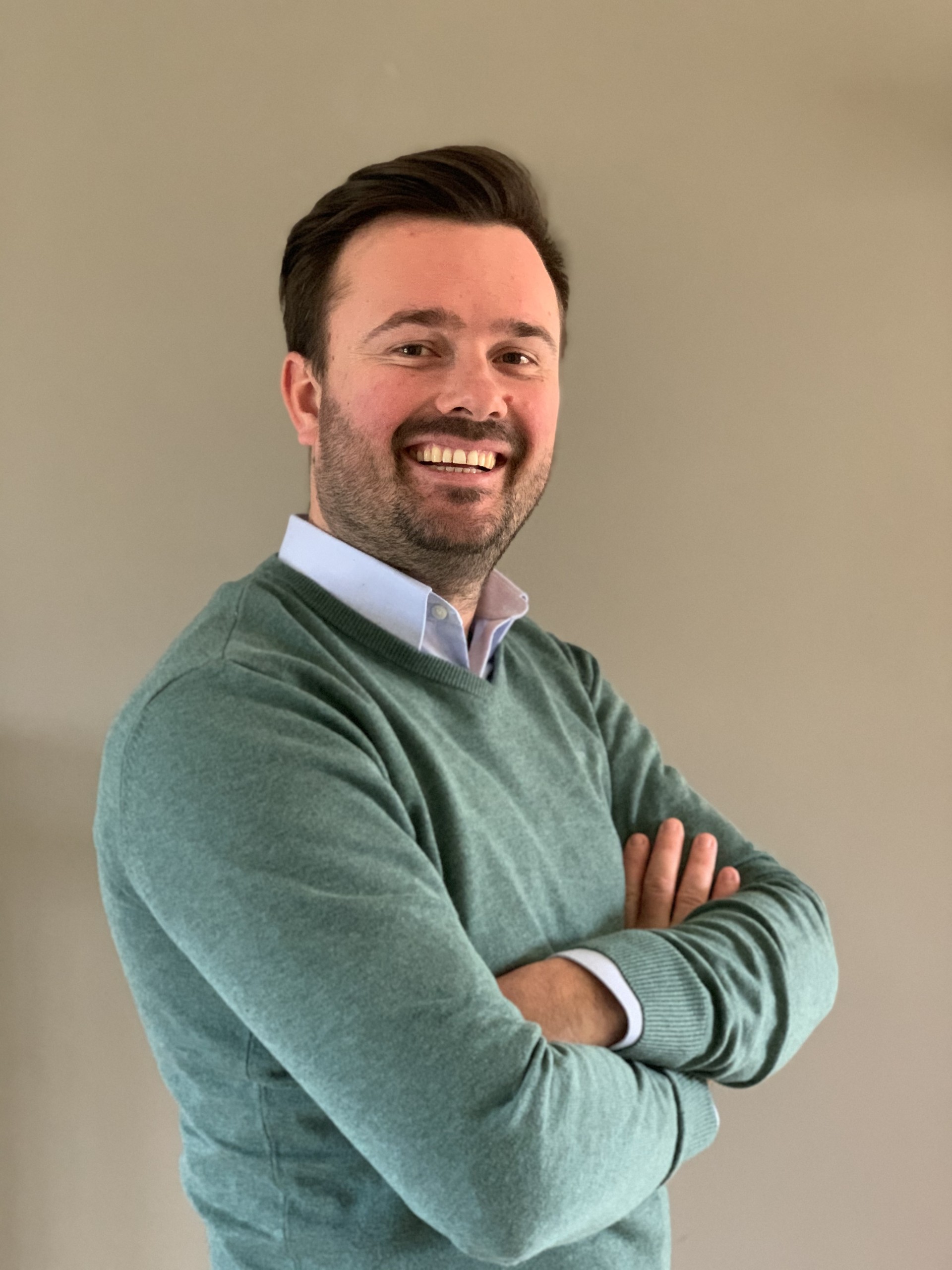 Smiling headshot of Pieter Claes in a green sweater.