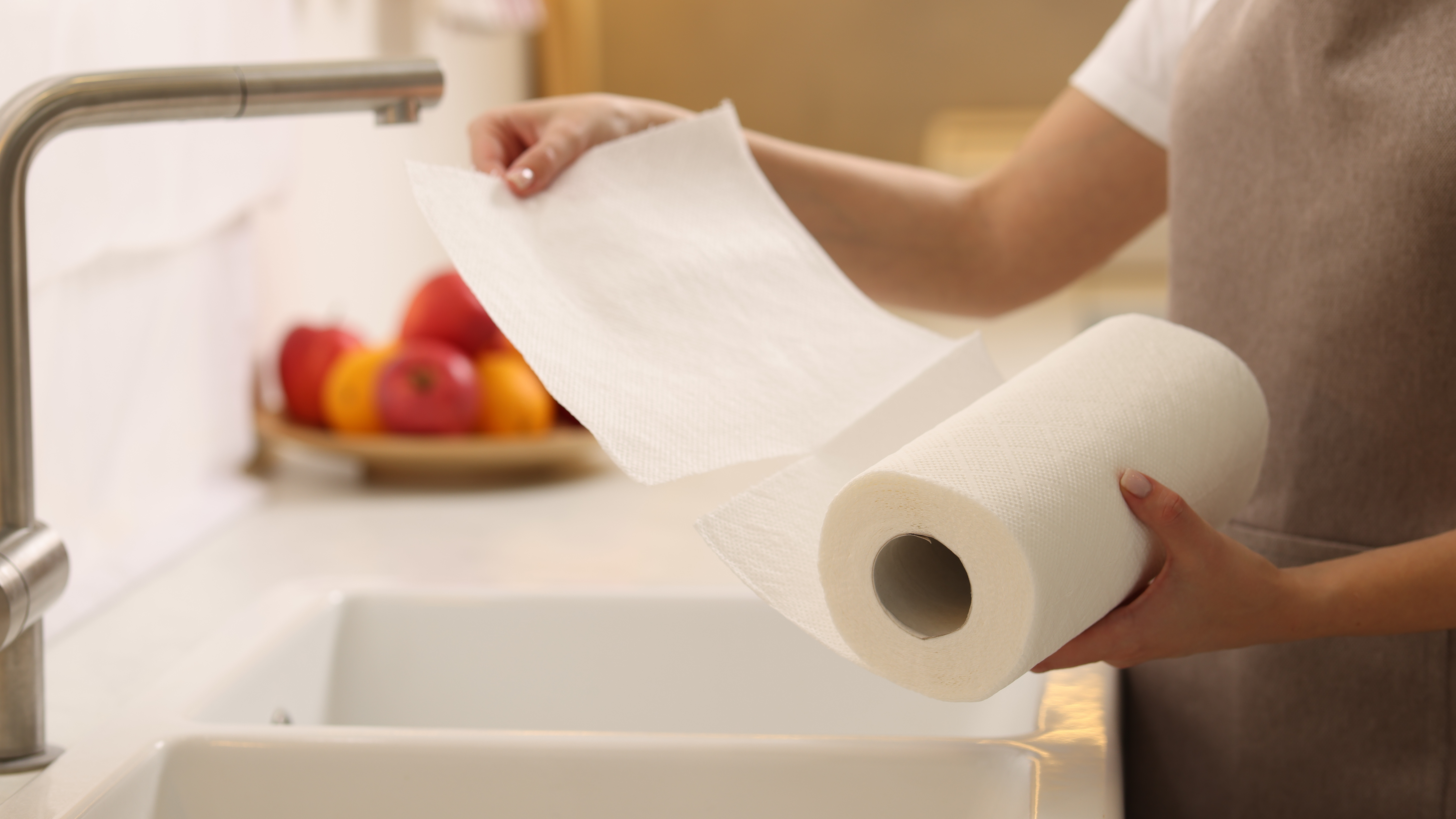 Rolling out a kitchen towel by a sink