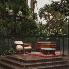 The conservatory at the Barbican with a display of a few pieces from the MADE x Barbican homeware collection including the Plinth coffee table and the Dual armchair