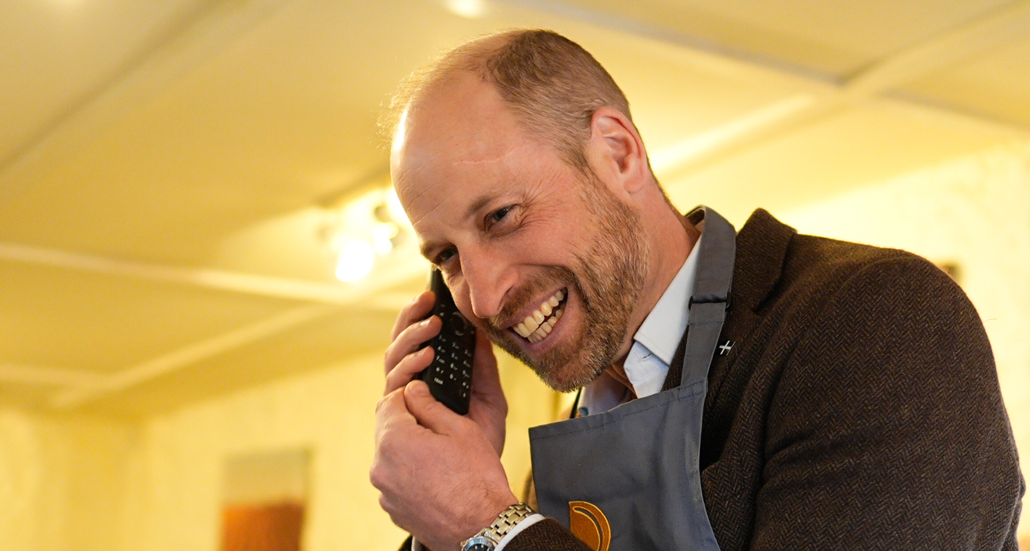 Prince William answering a phone and laughing