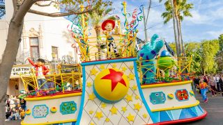Miguel from Coco, Jessie from Toy Story, and Mike and Sully from Monsters Inc on a parade float at Disney California Adventure