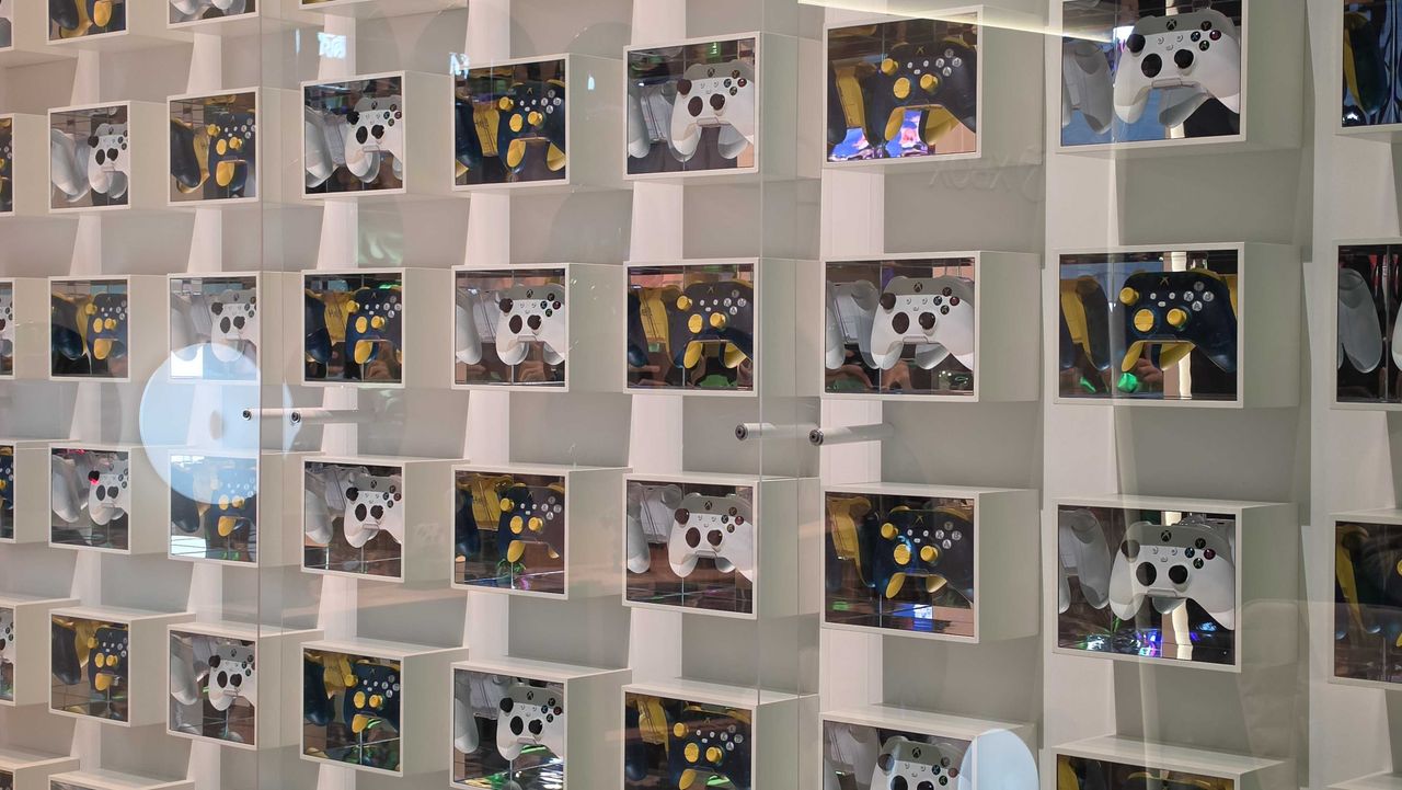 A wall of Xbox controllers in individual storage boxes