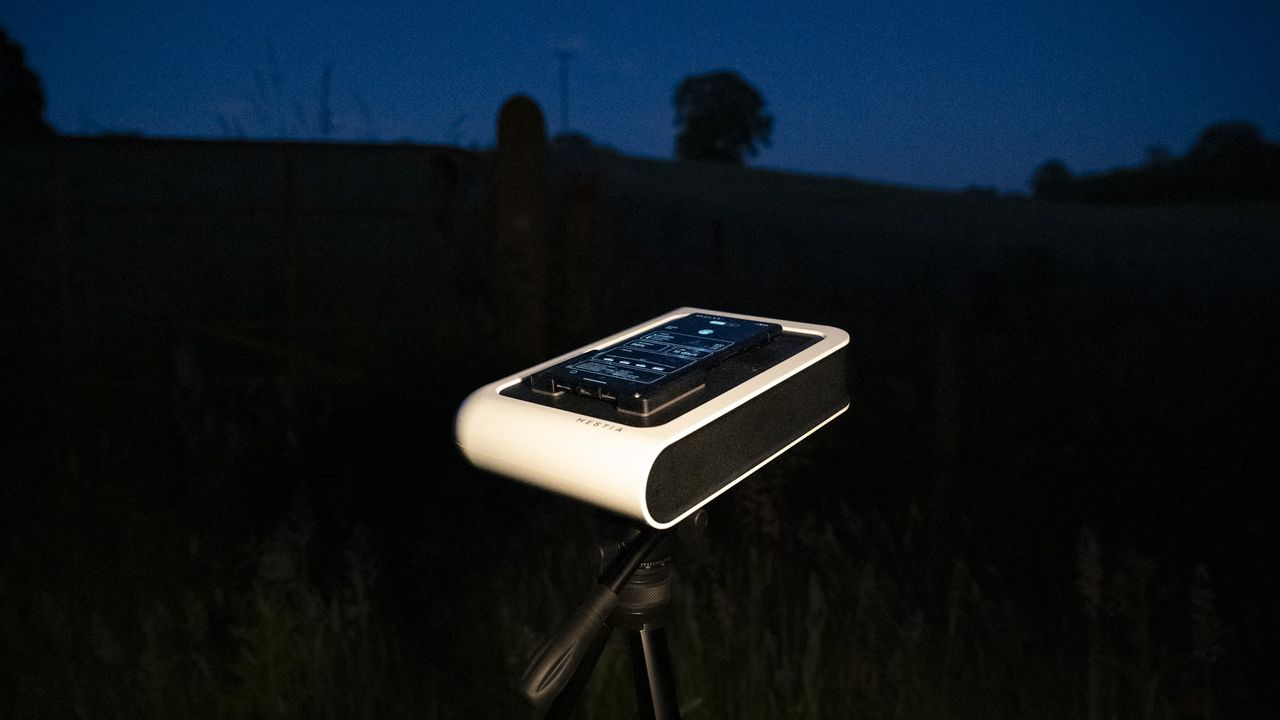 Vaonis Hestia smart telescope on a tripod pointing up at the night sky with a Google Pixel phone attached