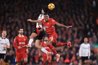 Raul Jimenez of Fulham battles with Ryan Gravenberch of Liverpool during the Premier League match between Liverpool FC and Fulham FC at Anfield on December 14, 2024 in Liverpool, England