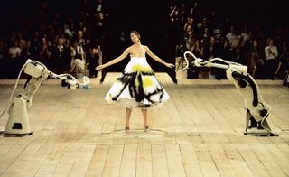 Another career highlight captured in this room is S/S 1999's 'No 13' finale that saw Shalom Harlow standing on a turntable dressed in a buckled white dress being sprayed with paint by two robot arms. Courtesy of Catwalking