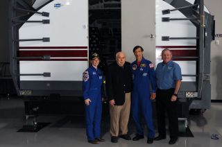 Former NASA astronauts Bonnie Dunbar and Mario Runco pose with former Johnson Space Center director George Abbey and Lone Star Flight Museum president and CEO Douglas Owens in front of the Shuttle Mission Simulator.