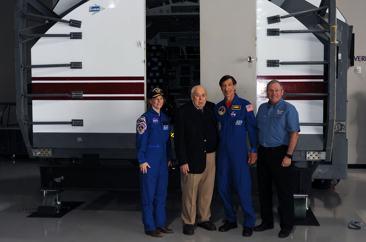 Bonnie Dunbar and Mario Runco were former NASA pilots with former Johnson Space Center director George Abbey and Lone Star Flight Museum President and CEO Douglas Owens in front of the Shuttle Mission Simulator.