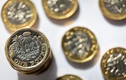 Several one pound coins on a white background