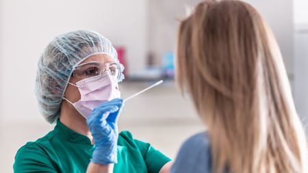 Doctor administers covid test to patient