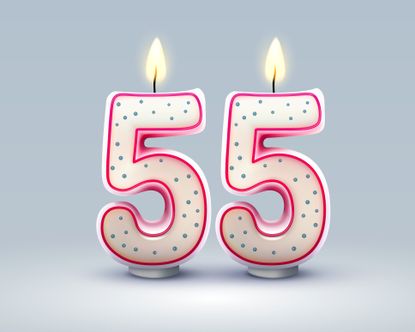 Two lit candles in the shape of the number 5, representing a 55th birthday. 
