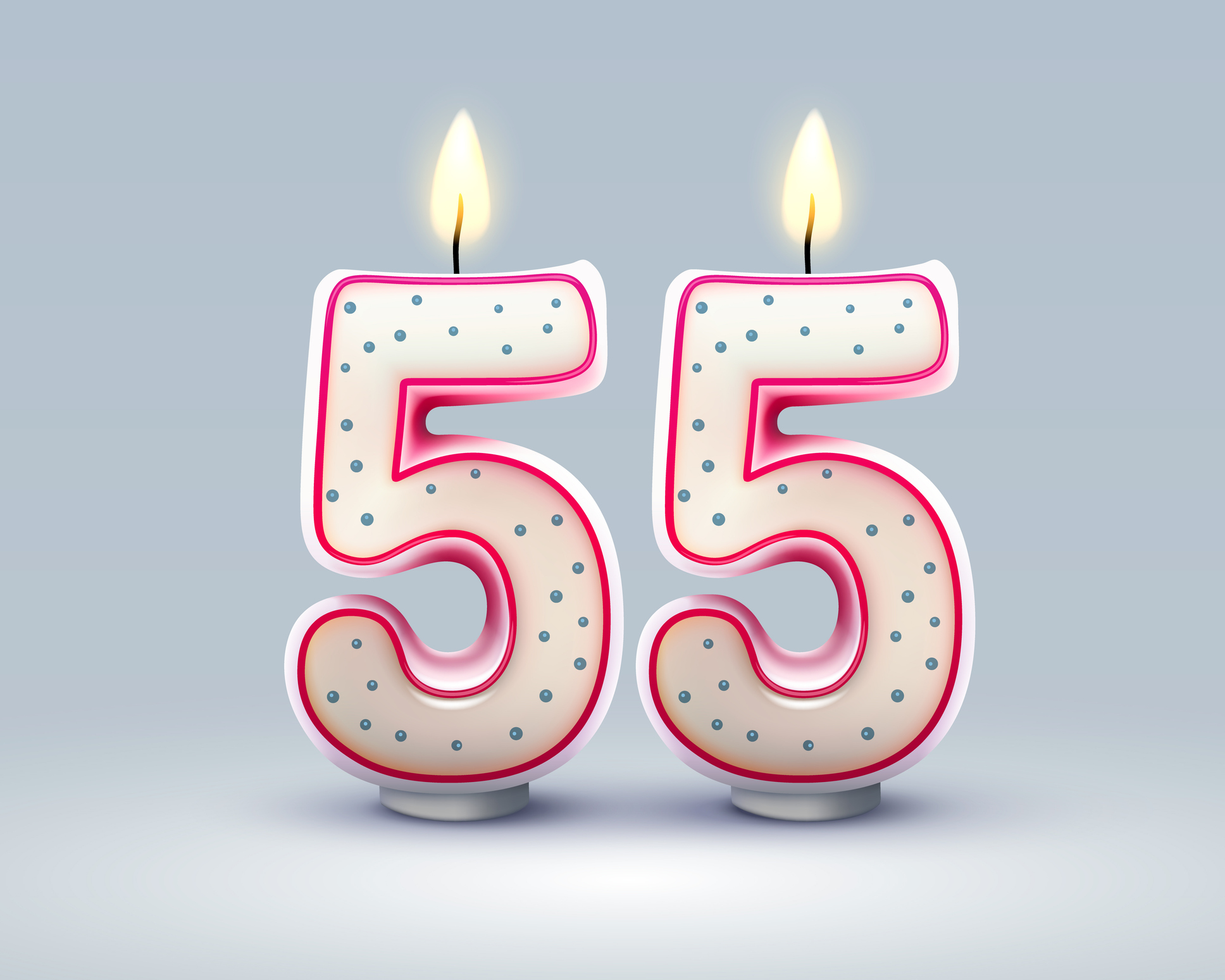 Two lit candles in the shape of the number 5, representing a 55th birthday. 