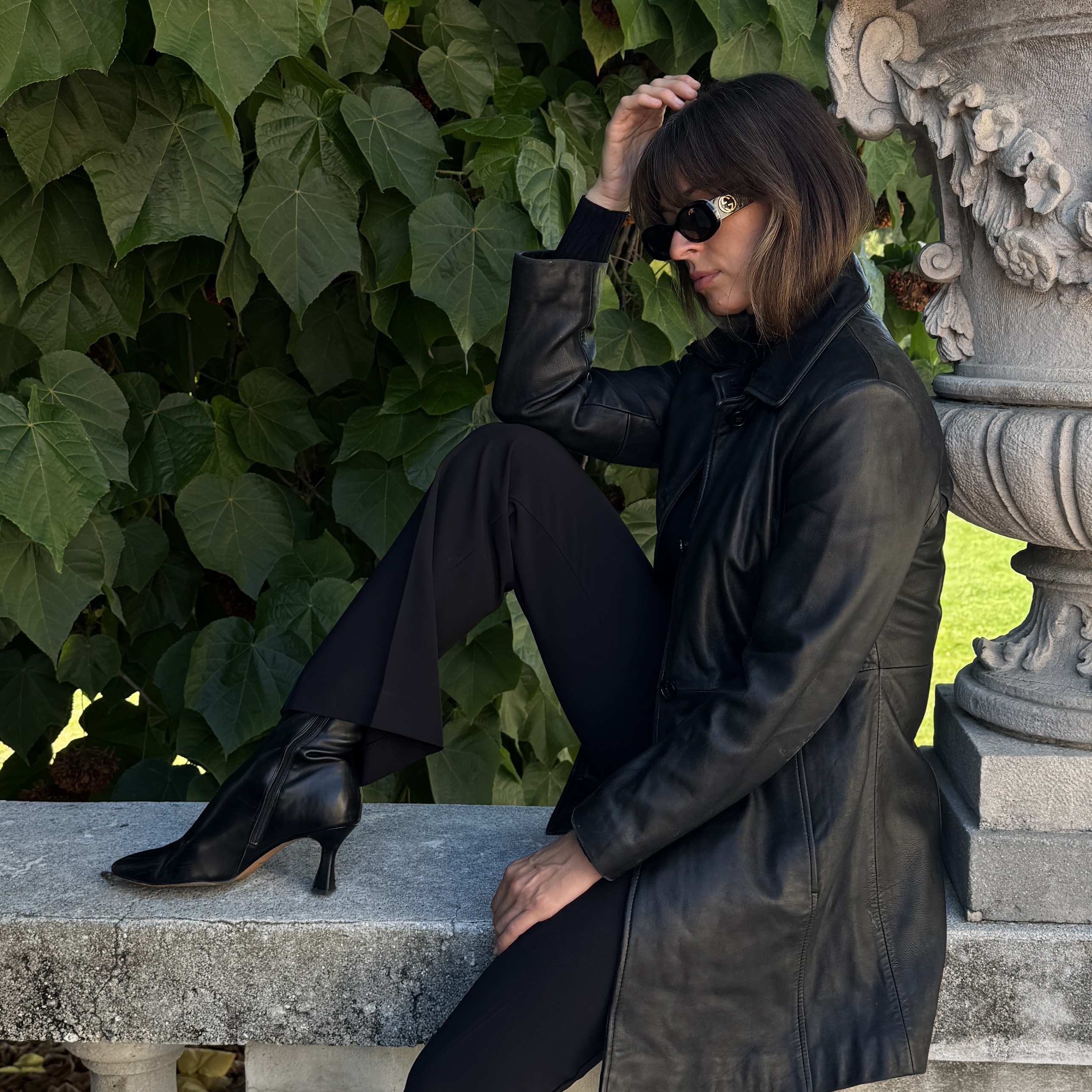 Kathryn Zahorak wearing black leather jacket, sunglasses, black boots