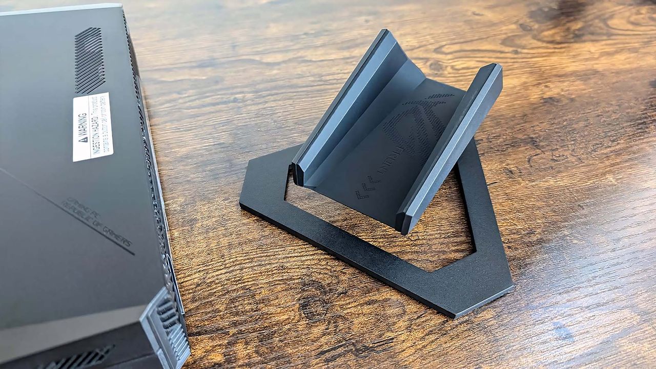 ASUS ROG NUC 970 Gaming Mini PC next to stand.