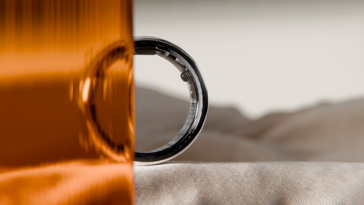 A press photo of the black Circular Ring 2 sitting half-obscured by an orange screen, with a desert view behind it