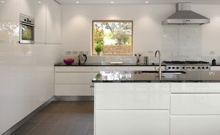 The kitchen features white units and clean lines