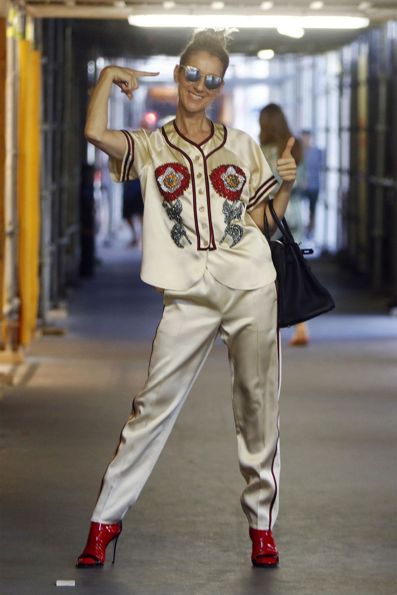 Going for the Gucci: Celine donned a matching silk outfit and red patent leather boots by the brand in Paris.