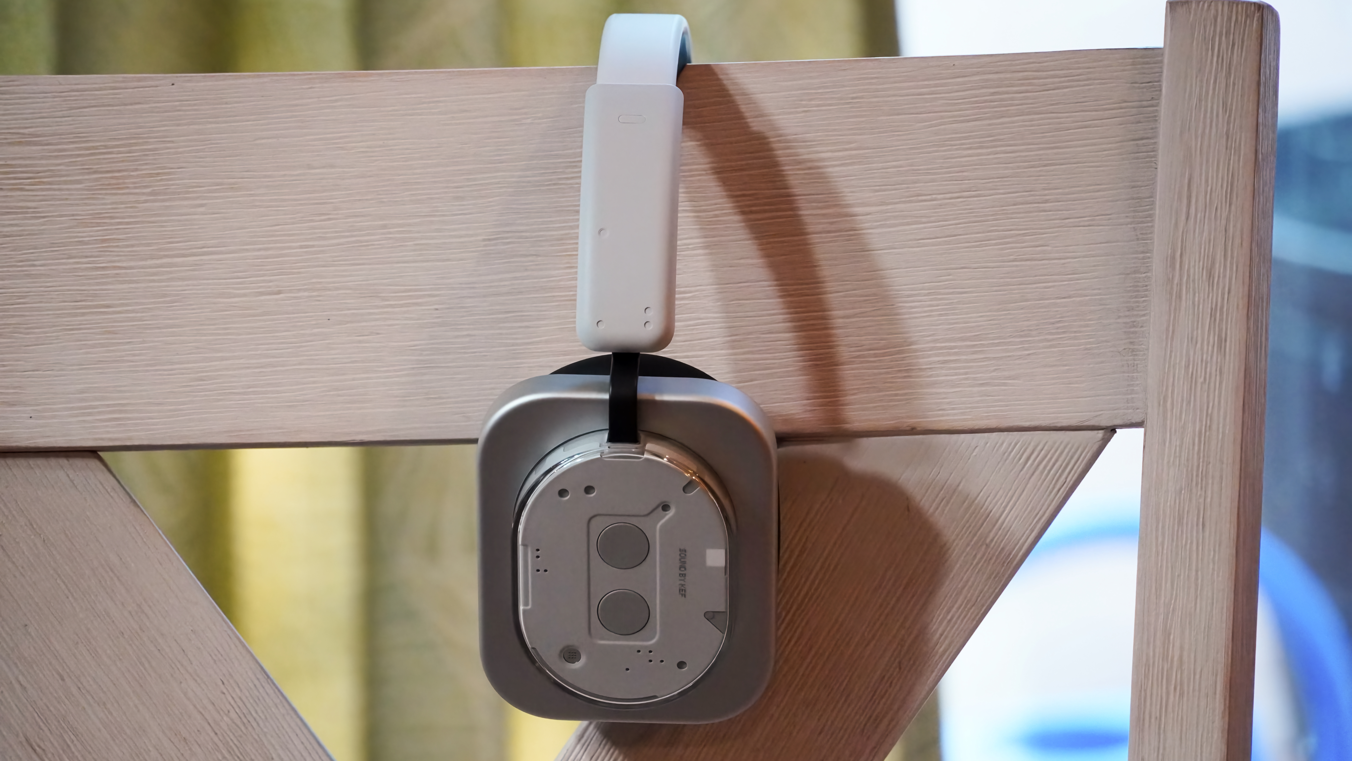 A side view of the Nothing Headphone 1 hanging from a chair.