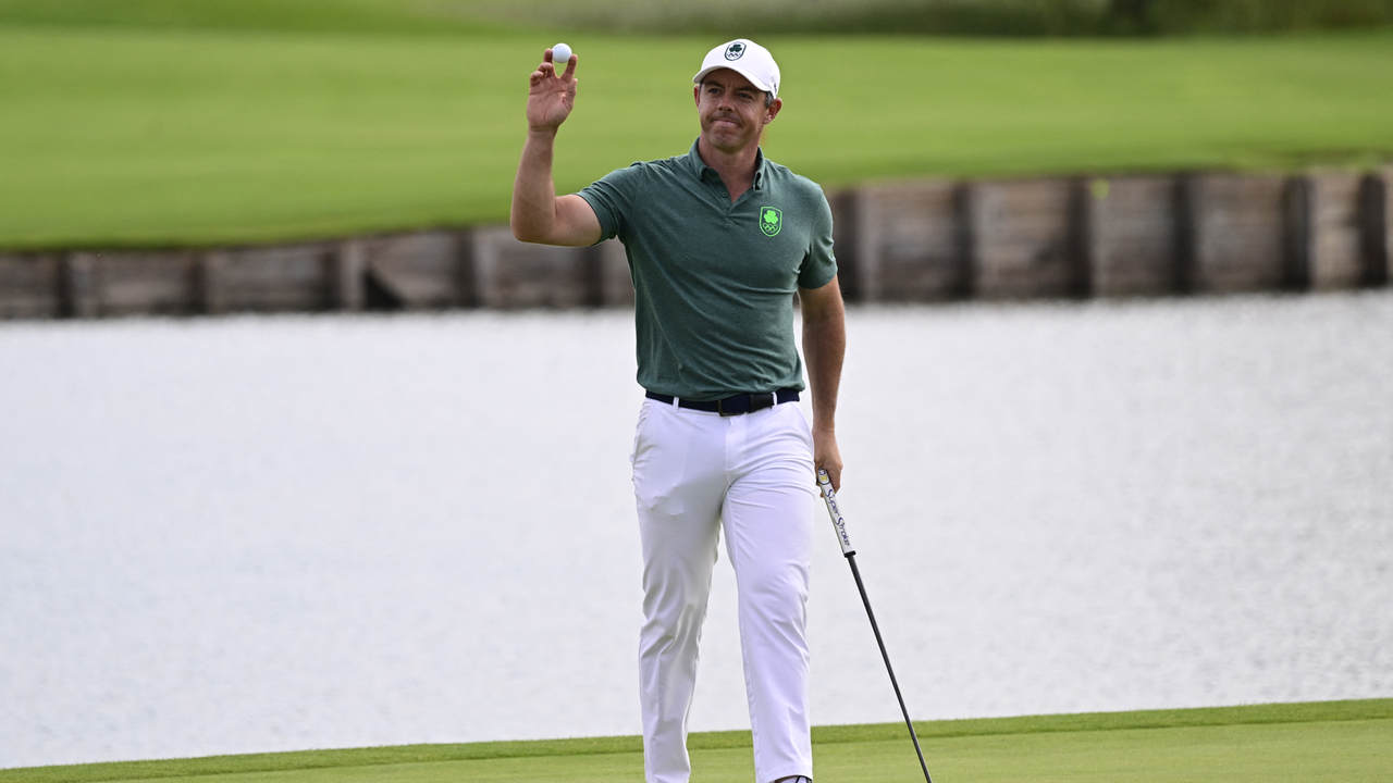 Rory McIlroy waves to the crowd after holding a putt