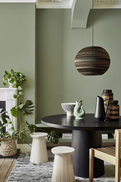 living room with green walls and white fireplace