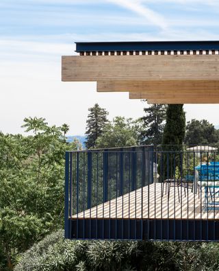 jewel box by red dot studio, a house jutting out of a leafy hill and looking out to views from large glazed side