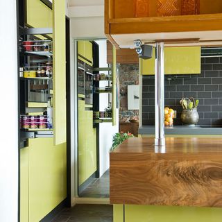 kitchen area with yellow cabinet and pull out shelf