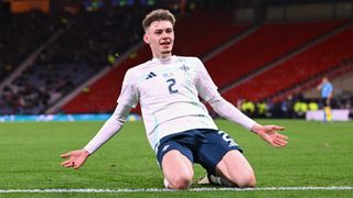 Northern Ireland&#039;s Conor Bradley celebrates after scoring against Scotland in March 2024.