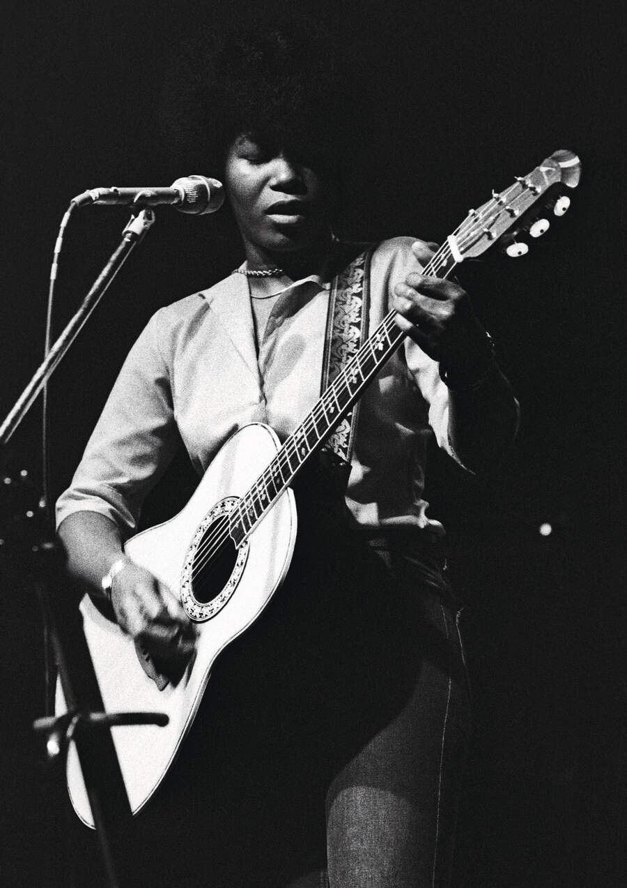 Joan Armatrading performing on stage at Hyde Park, London 31 May 1975