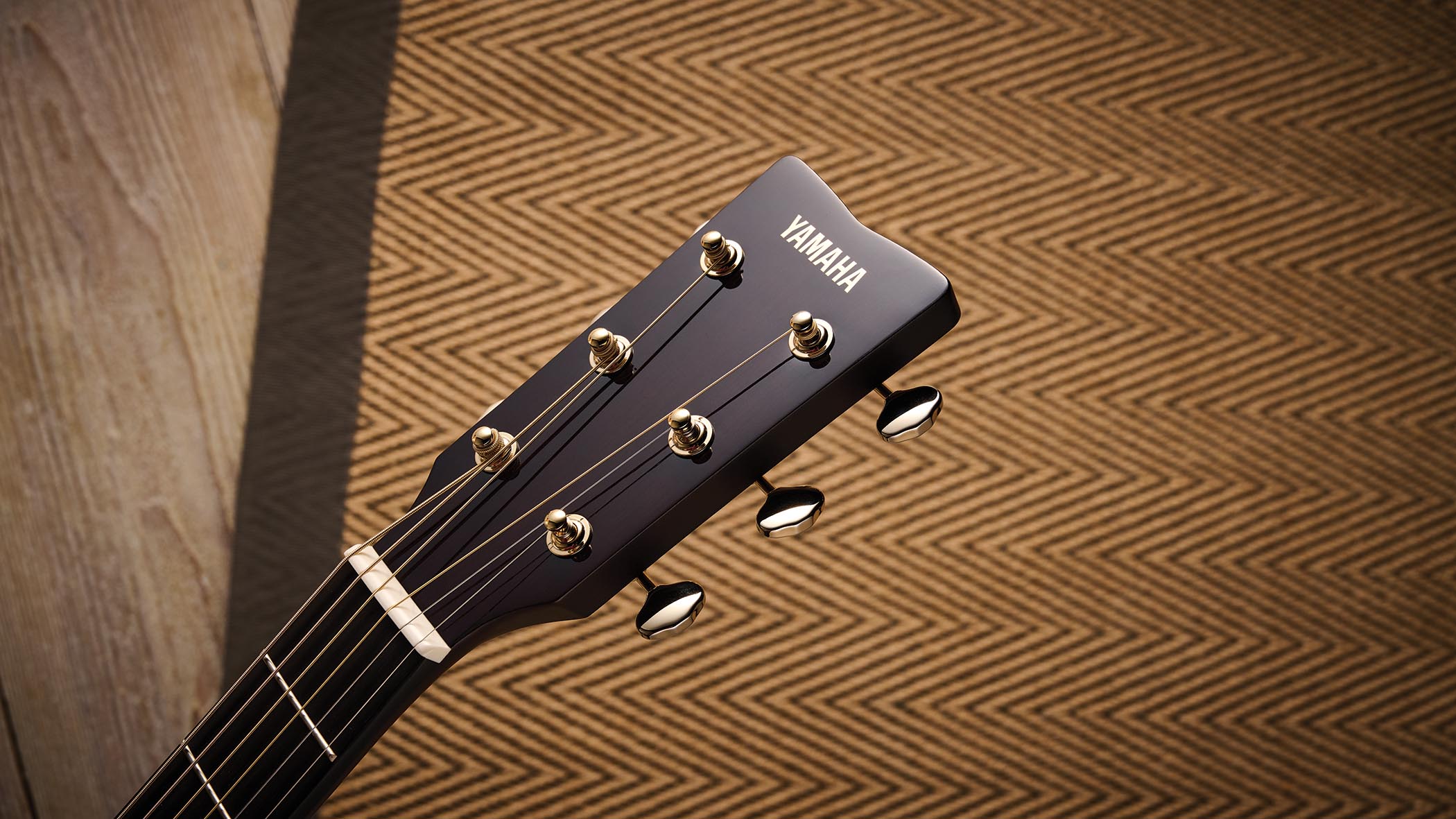 The Yamaha TransAcoustic TAG3 C is a cutaway acoustic guitar with a sandburst finished, photographed in closeup
