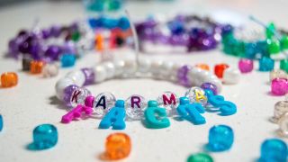 A freindship bracelets that says "Karma Facts"