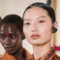 models backstage at hermes spring 2025 show with fresh glowy shkin 