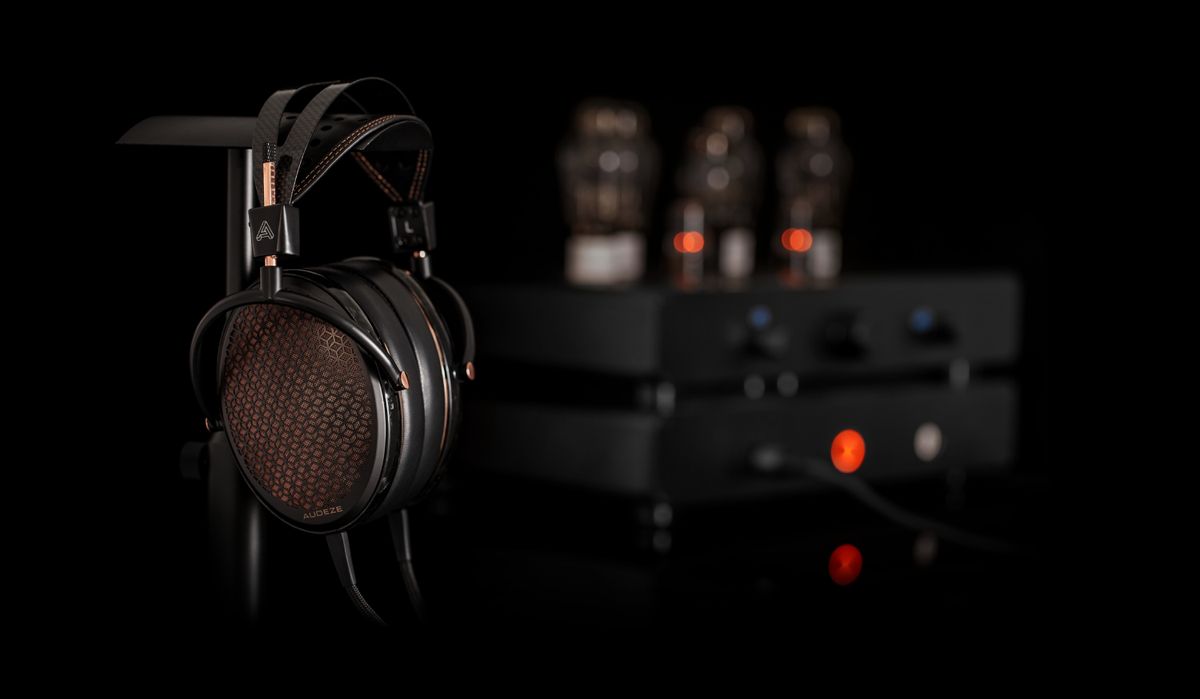 Audeze CRBN2 headphones with an amplifier in the background