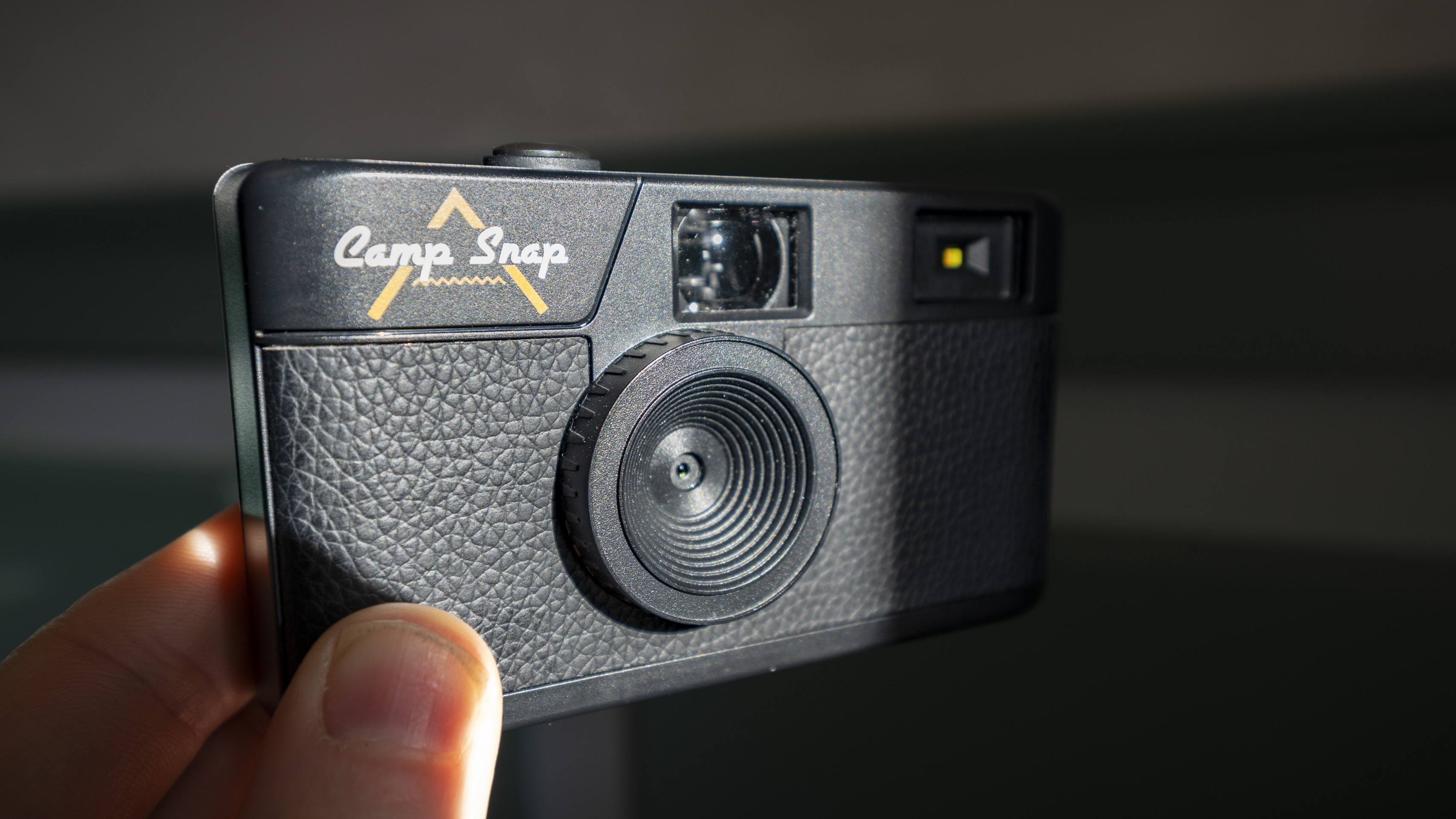 Camp Snap Camera in the hand illuminated by high contrast window light