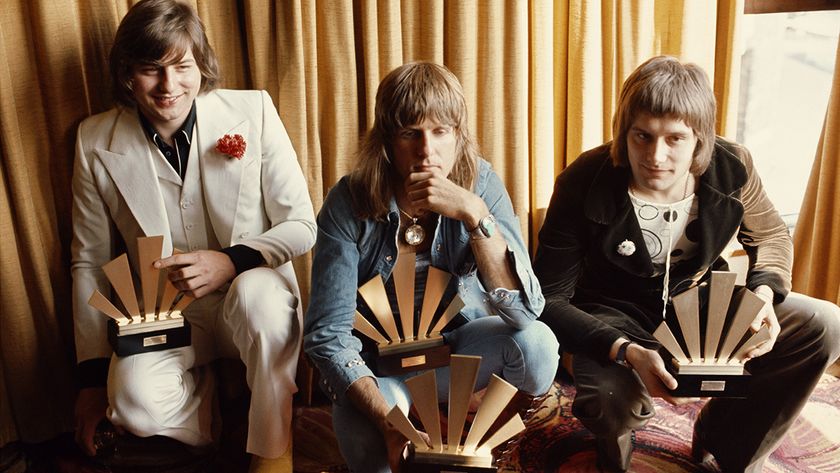 Rock musicians (from left to right) Greg Lake (1947 - 2016), Keith Emerson (1944 - 2016), and Carl Palmer, of the group Emerson Lake And Palmer receive their awards at the 1972 Melody Maker Pop Poll; readers of the weekly music paper voted ELP the World&#039;s Top Group, and between then they won seven awards, 30th September 1972. (Photo by Michael Putland/Getty Images)