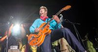 Brian Setzer wears a red neckerchief and plays a Gretsch in traditional Round-up Orange in this Stray Cats performance from 2019.