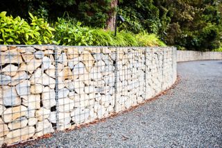 sloping garden ideas: gabion wall in a sloping garden