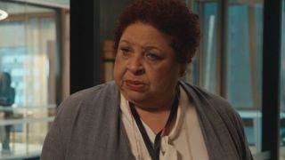 Patricia Belcher stands with a concerned expression in conversation in Matlock S1 E2 - "Rome, in a Day."