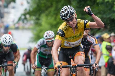 Tom Zirbel (Optum) raises his arm after taking the overall race win.