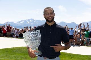 Steph Curry holding the American Century Championship trophy