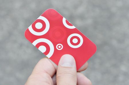 Vancouver, British Columbia, Canada -- August 23, 2014:Close up of a man holding a Target Gift Card in his hand. Target is an American discount retail chain that recently expanded to Canada.