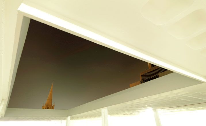 A view up into an attic-like space, with the tops of two model buildings just visible