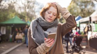 tired woman looking at her phone